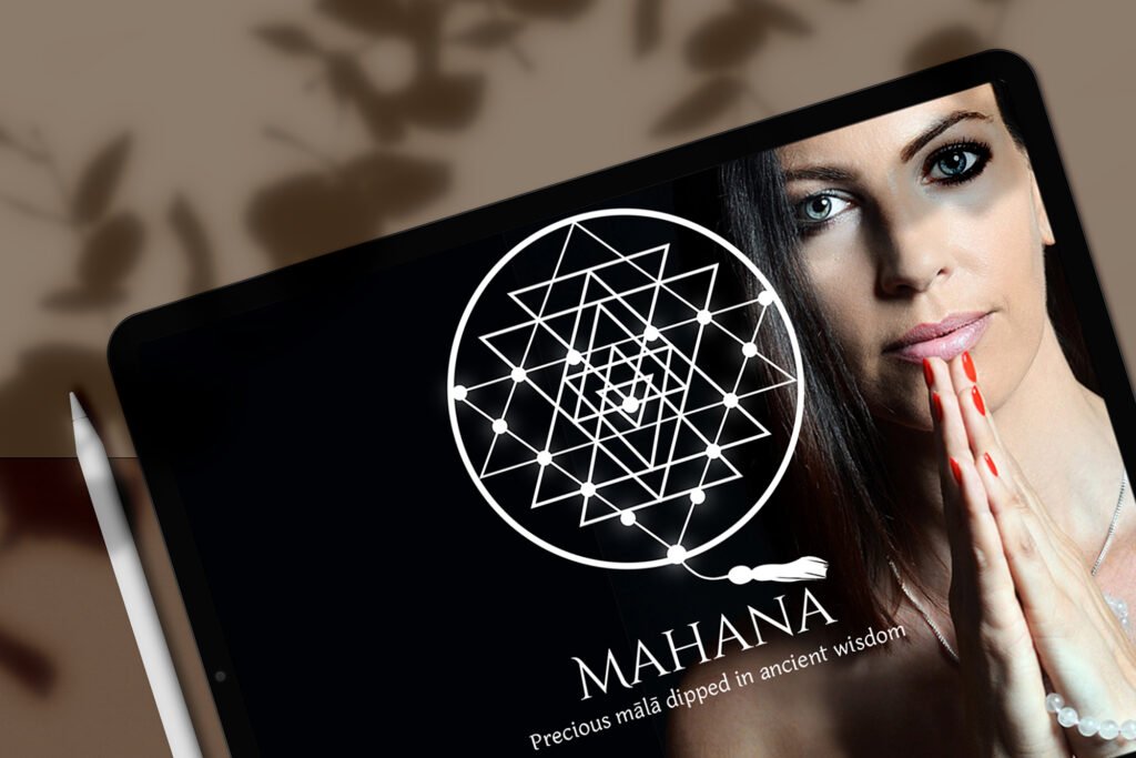 Mahana logo by Amritaé Design, featuring a sacred geometry Sri Yantra symbol representing divine balance and ancient wisdom, on which there is highlighted a mala. The logo is displayed on a digital tablet beside a serene portrait of the owner, Hana, in prayer.
